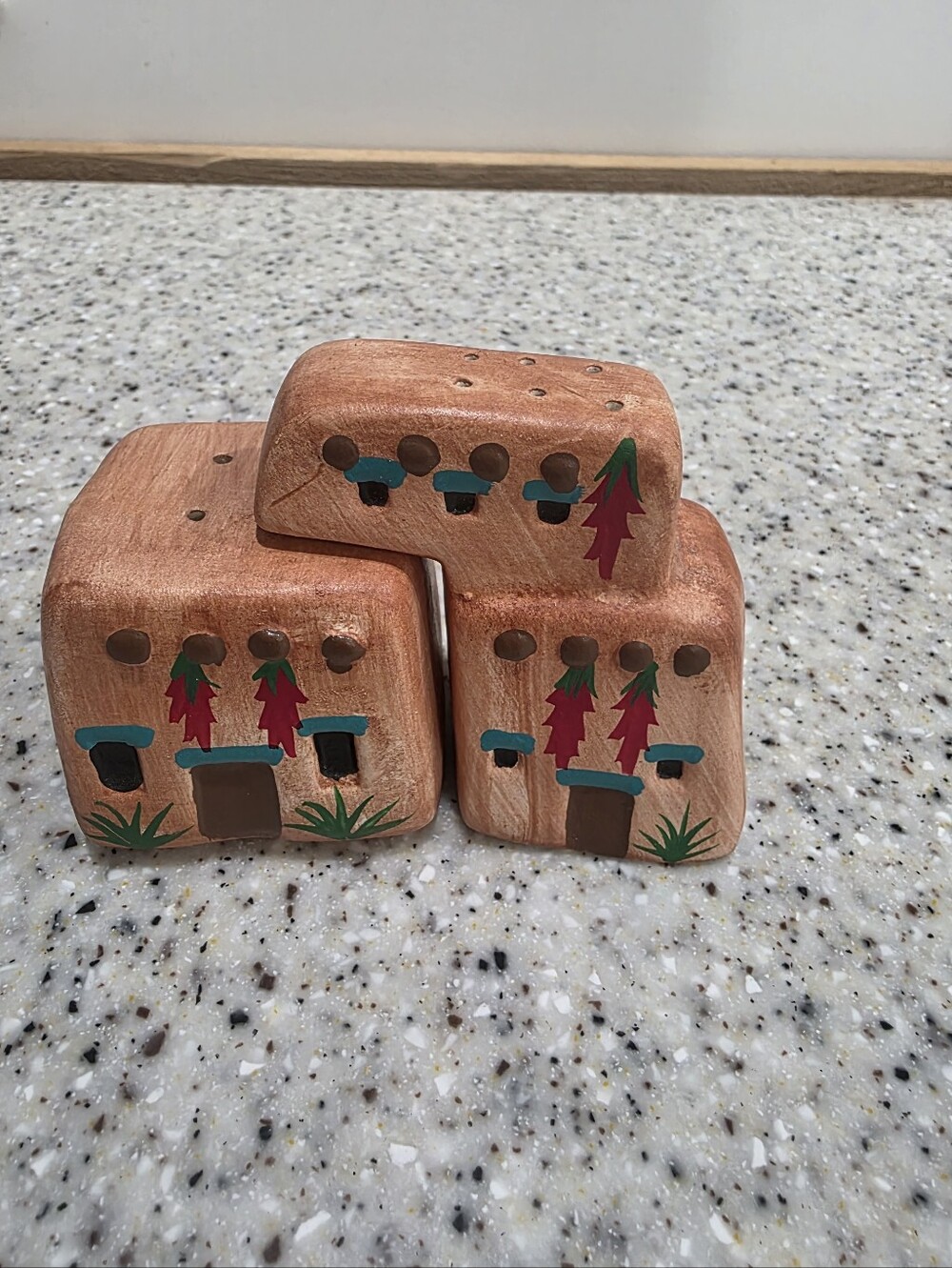Vintage Southwestern adobe-style hand-painted wooden salt and pepper shakers.